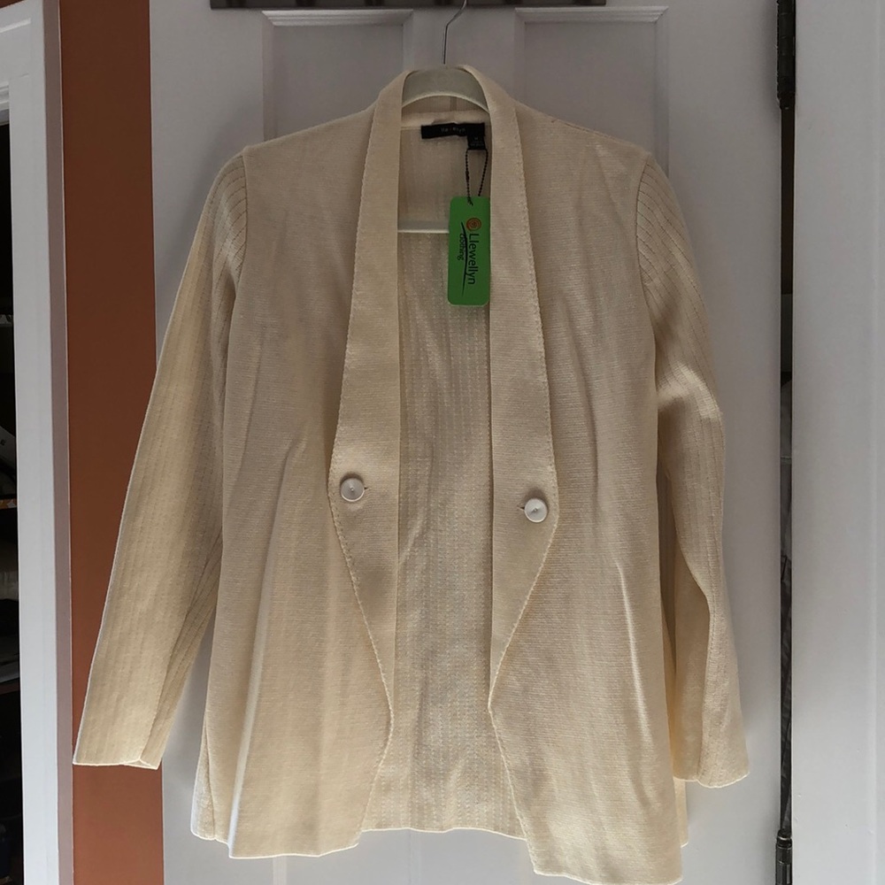 Cream merino wool jacket/cardigan.Ribbed back and sleeves contrast with the knit